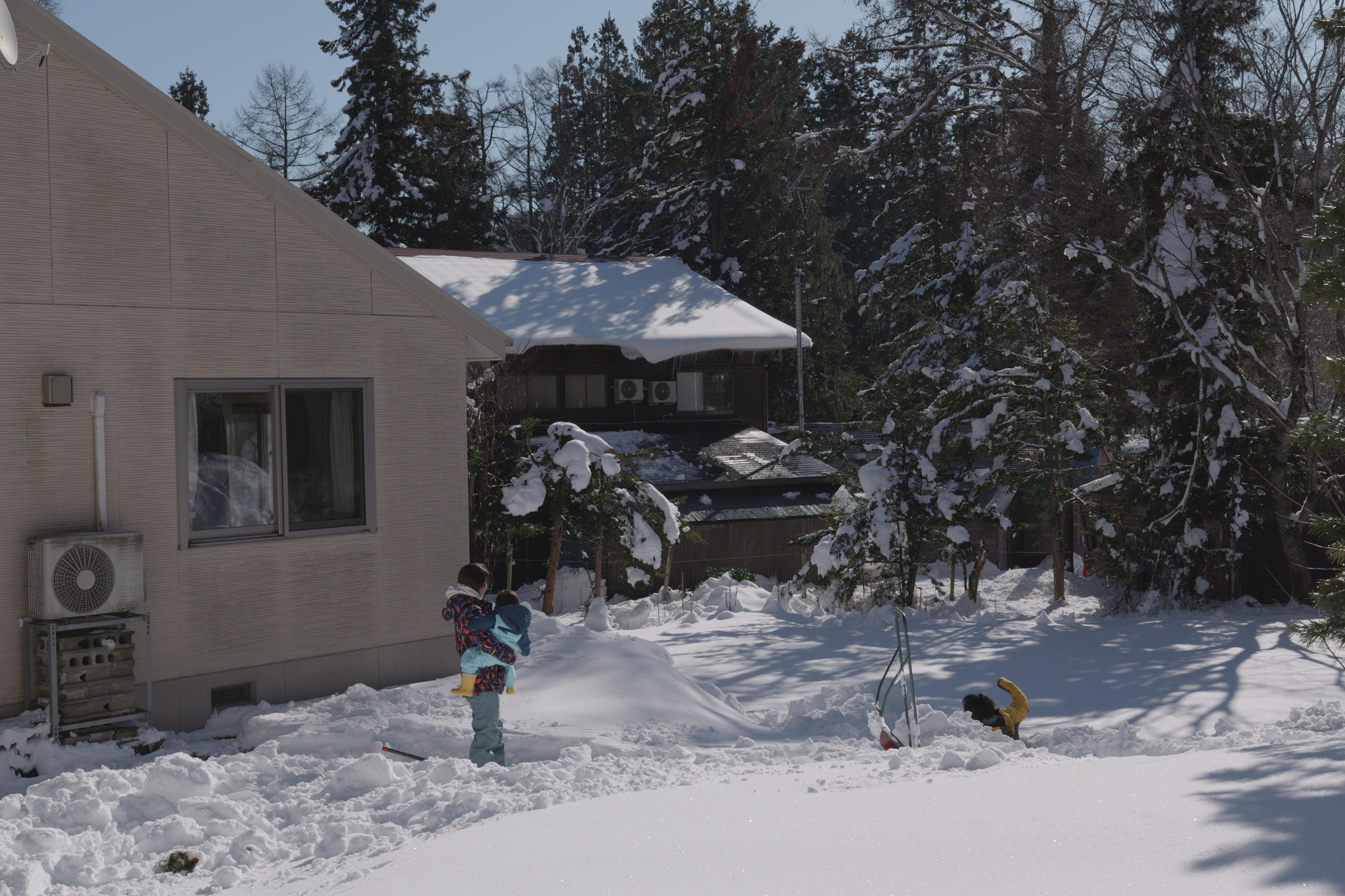 Garden in winter with kids playing